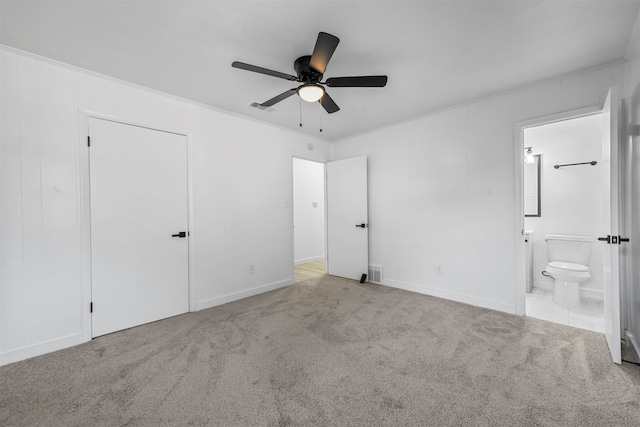 unfurnished bedroom with ensuite bathroom, ceiling fan, ornamental molding, and light colored carpet