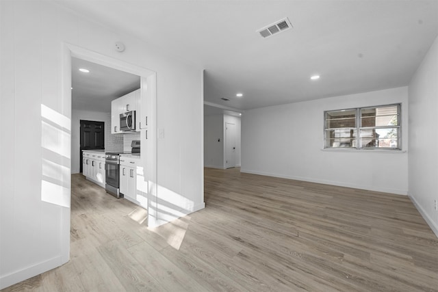 unfurnished living room featuring light wood-type flooring