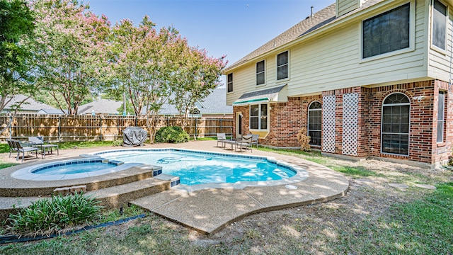 view of swimming pool with a patio and an in ground hot tub