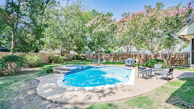 view of swimming pool with a patio and an in ground hot tub