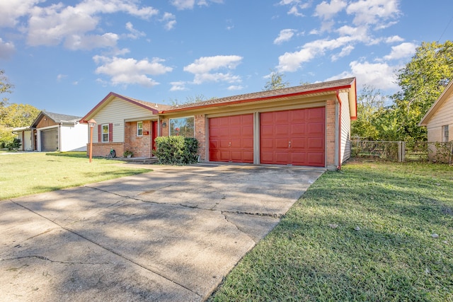 single story home with a garage and a front lawn