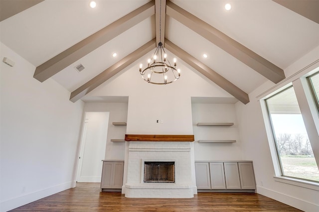 unfurnished living room with a brick fireplace, dark wood-style floors, baseboards, and beamed ceiling