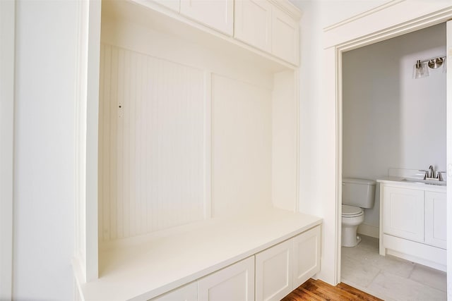 mudroom featuring sink and light hardwood / wood-style flooring