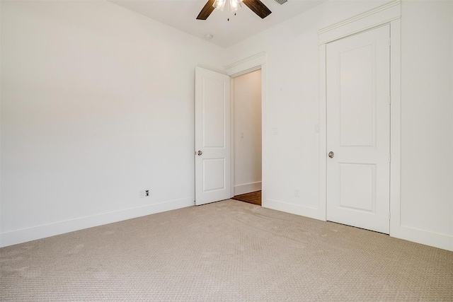 unfurnished bedroom with carpet floors, visible vents, ceiling fan, and baseboards