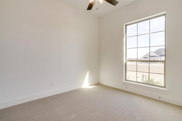 unfurnished room with ceiling fan, baseboards, and light colored carpet