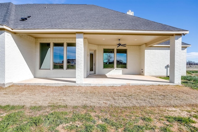 back of property featuring ceiling fan and a patio