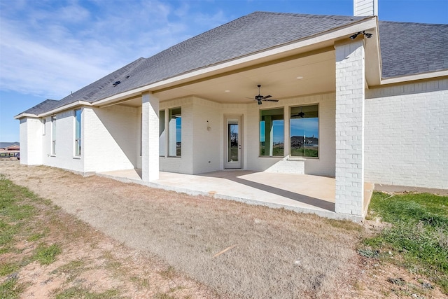 rear view of house featuring ceiling fan and a patio