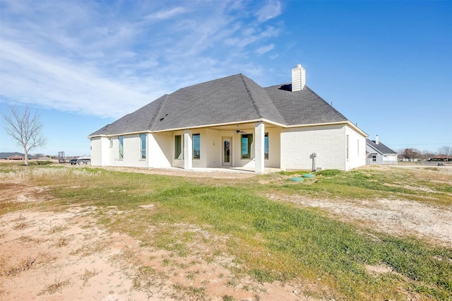 rear view of house with a chimney and a patio area