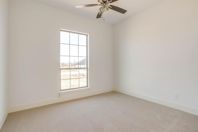 unfurnished room featuring carpet flooring, a wealth of natural light, and ceiling fan