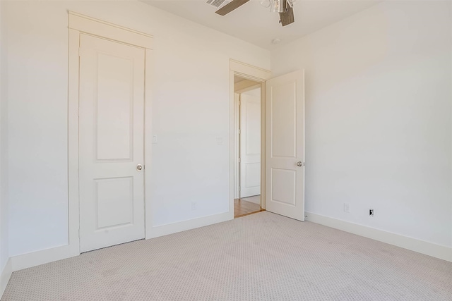 unfurnished bedroom featuring light carpet and ceiling fan