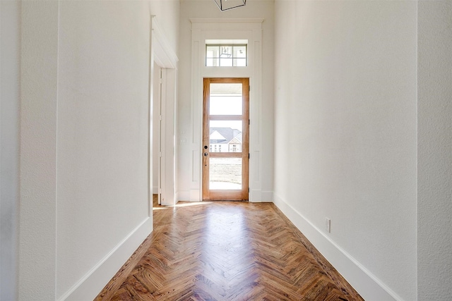 doorway to outside featuring baseboards