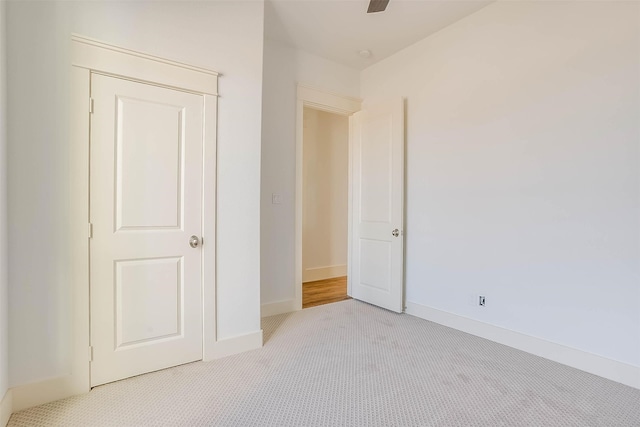 unfurnished bedroom with light colored carpet