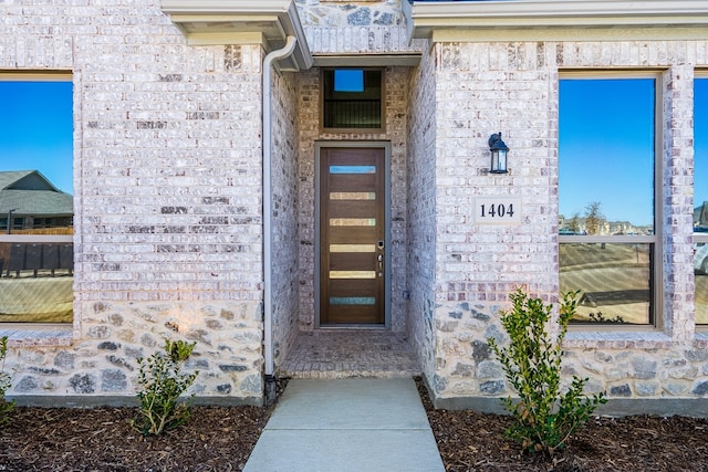 property entrance with stone siding