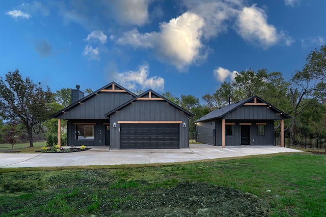 view of front of property featuring a garage and a front lawn