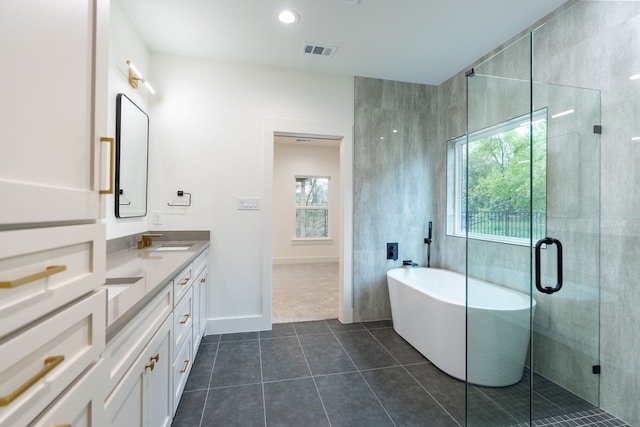 bathroom featuring vanity, tile patterned flooring, a healthy amount of sunlight, and separate shower and tub