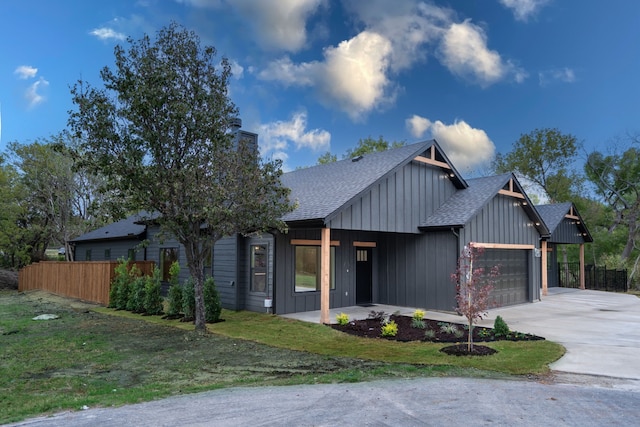 modern farmhouse style home with a front lawn and a garage