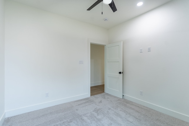 empty room featuring light colored carpet and ceiling fan