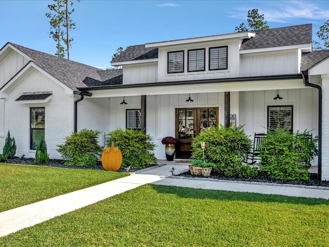 view of front of house featuring a front yard and covered porch