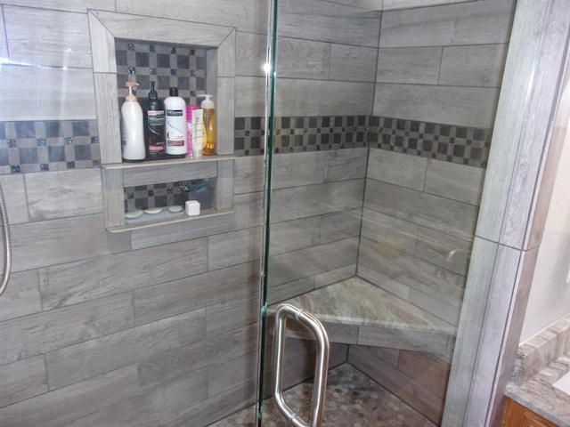 bathroom featuring a shower with door