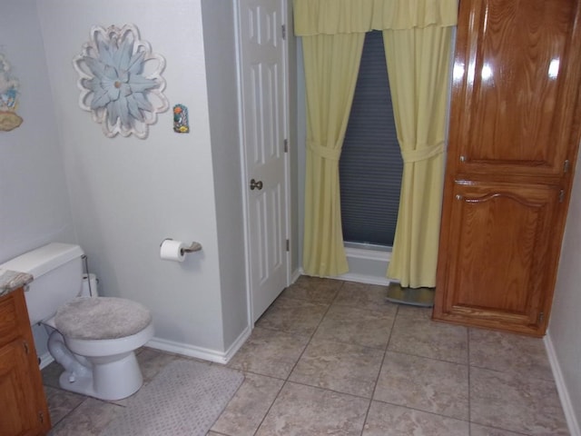 bathroom with toilet and tile patterned floors