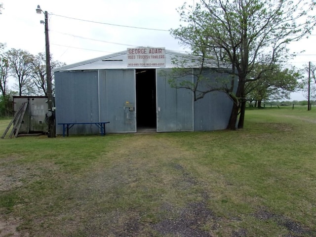 view of outbuilding with a lawn