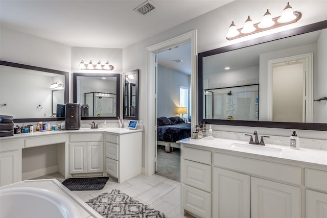 bathroom with tile patterned flooring, shower with separate bathtub, and vanity