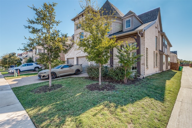 view of front of property featuring a garage and a front yard