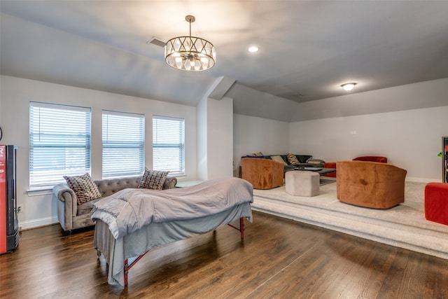 bedroom with dark hardwood / wood-style flooring and a chandelier