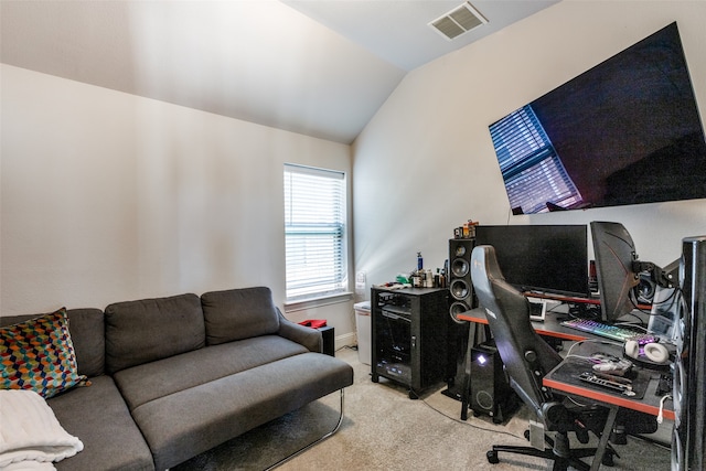 carpeted office space with vaulted ceiling