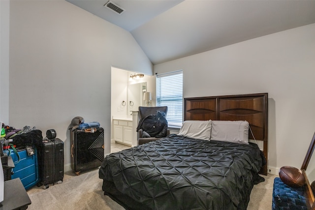 carpeted bedroom with connected bathroom and vaulted ceiling