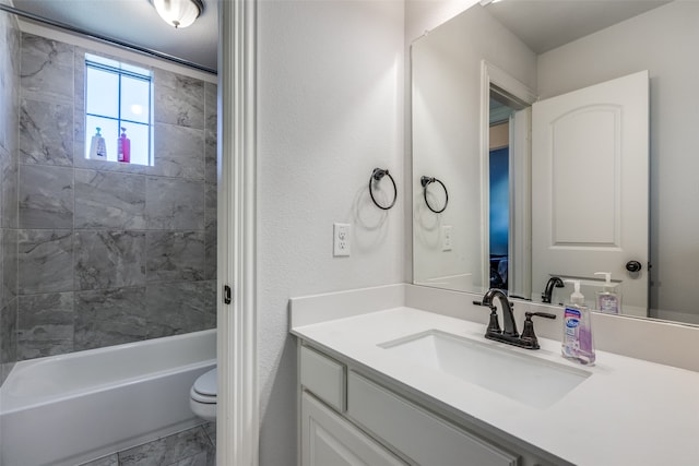 full bathroom with vanity, toilet, and tiled shower / bath