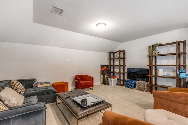 living room with carpet and vaulted ceiling