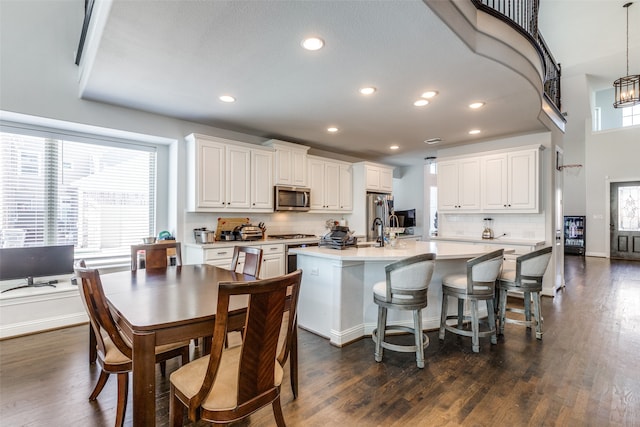 kitchen with white cabinets, a wealth of natural light, and dark wood-type flooring