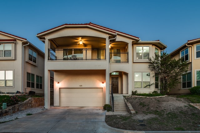 view of front of property featuring a garage and a balcony