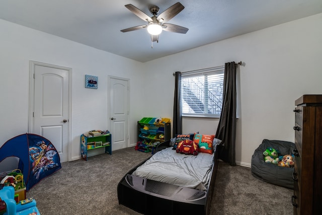 bedroom featuring dark colored carpet and ceiling fan