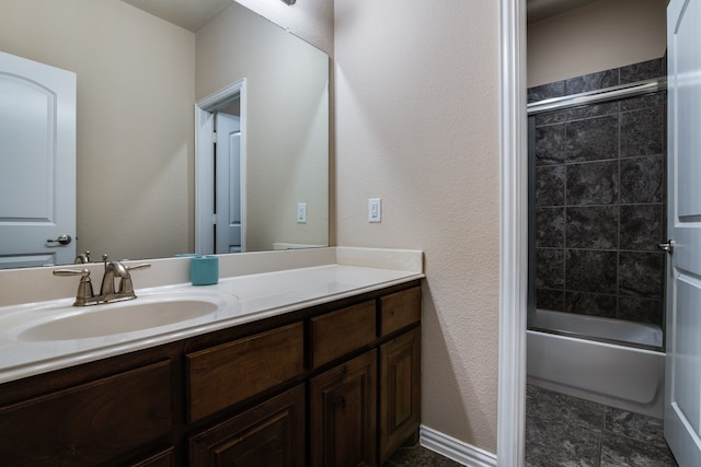 bathroom with enclosed tub / shower combo and vanity