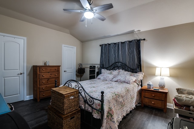 bedroom with dark wood-type flooring, vaulted ceiling, and ceiling fan