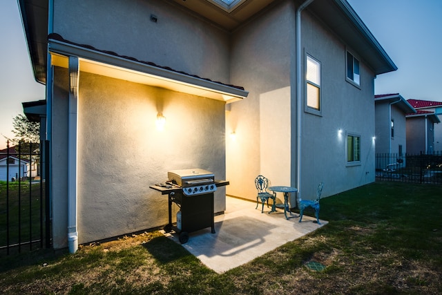 rear view of house with a lawn and a patio area