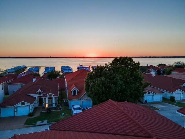 aerial view at dusk with a water view