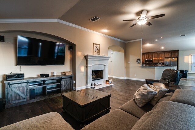 living room featuring ornamental molding, dark hardwood / wood-style floors, sink, lofted ceiling, and ceiling fan