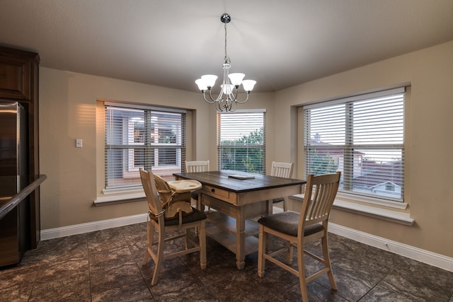 dining space with an inviting chandelier