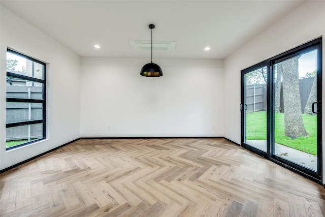 spare room featuring a wealth of natural light and light parquet flooring