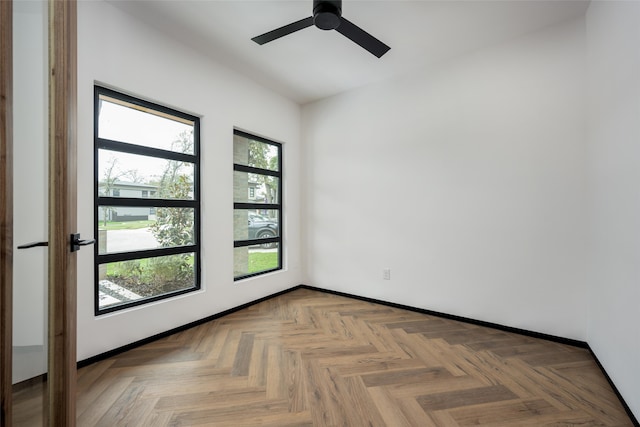 unfurnished room featuring ceiling fan and light parquet floors