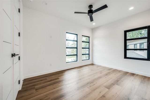 spare room featuring hardwood / wood-style floors and a wealth of natural light