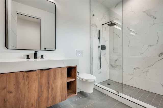 bathroom with tile patterned flooring, vanity, toilet, and tiled shower