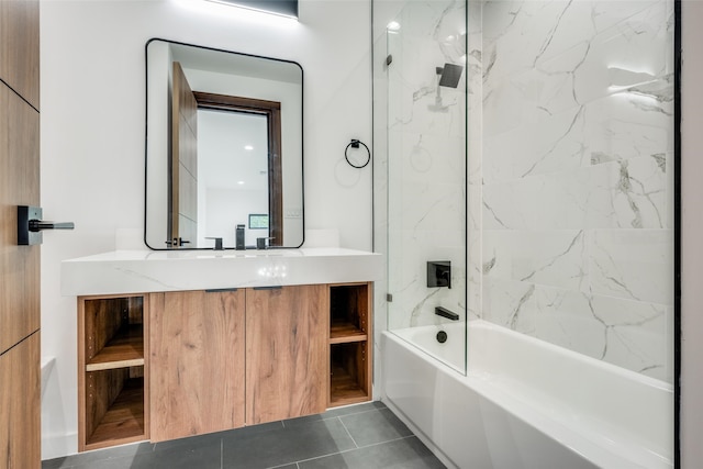 bathroom featuring tile patterned flooring, vanity, and tiled shower / bath