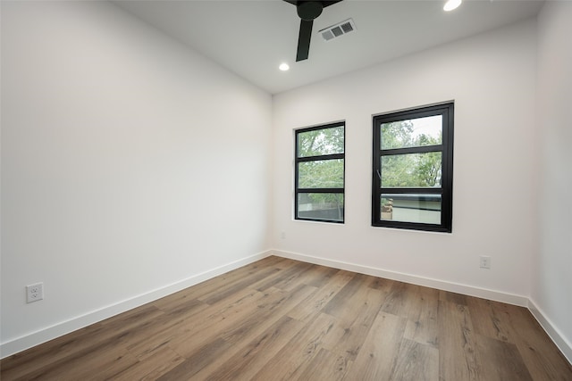 spare room featuring light hardwood / wood-style flooring and ceiling fan