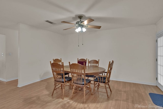 dining space with light wood-type flooring, a healthy amount of sunlight, and ceiling fan