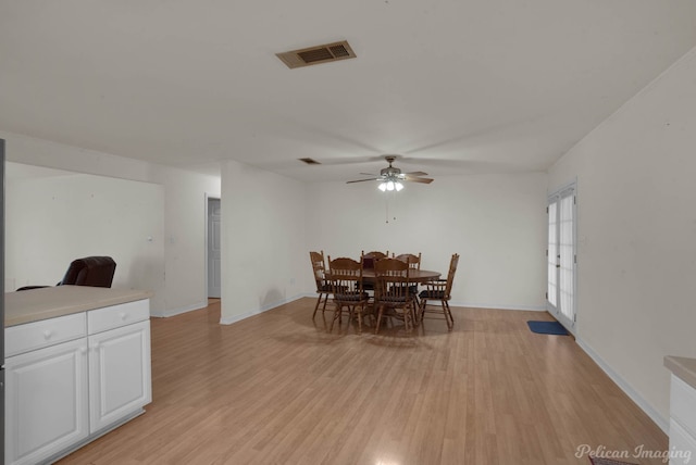 dining area with light hardwood / wood-style flooring and ceiling fan