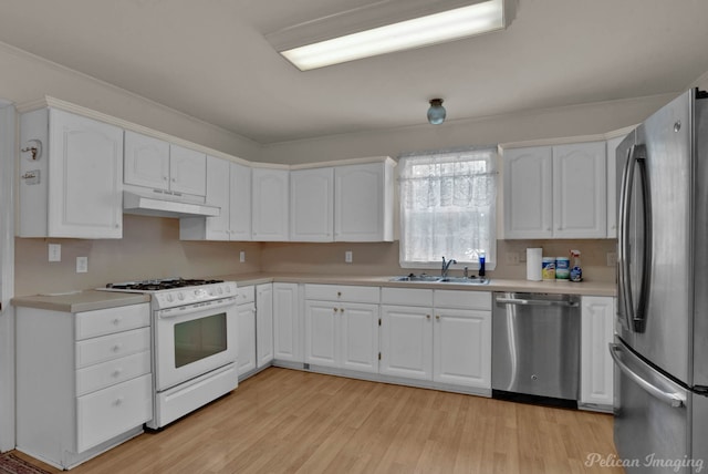 kitchen with light wood-type flooring, white cabinets, sink, and stainless steel appliances